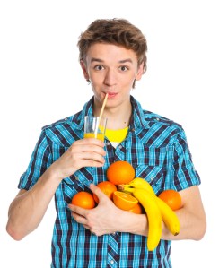 Portrait of a boy holding fruits